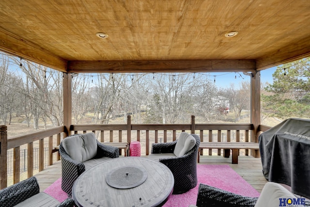 wooden deck with outdoor dining space and a grill