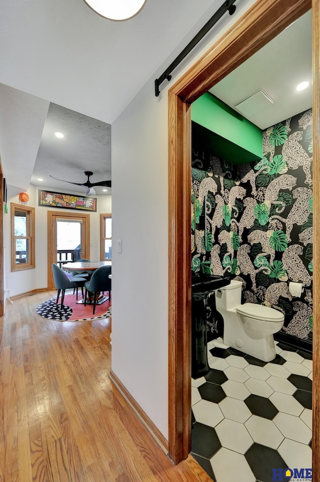 hall featuring light wood-type flooring and baseboards