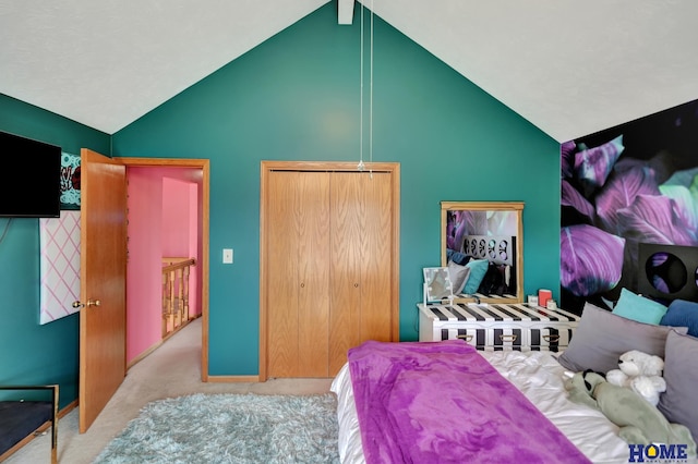 carpeted bedroom with a closet and lofted ceiling