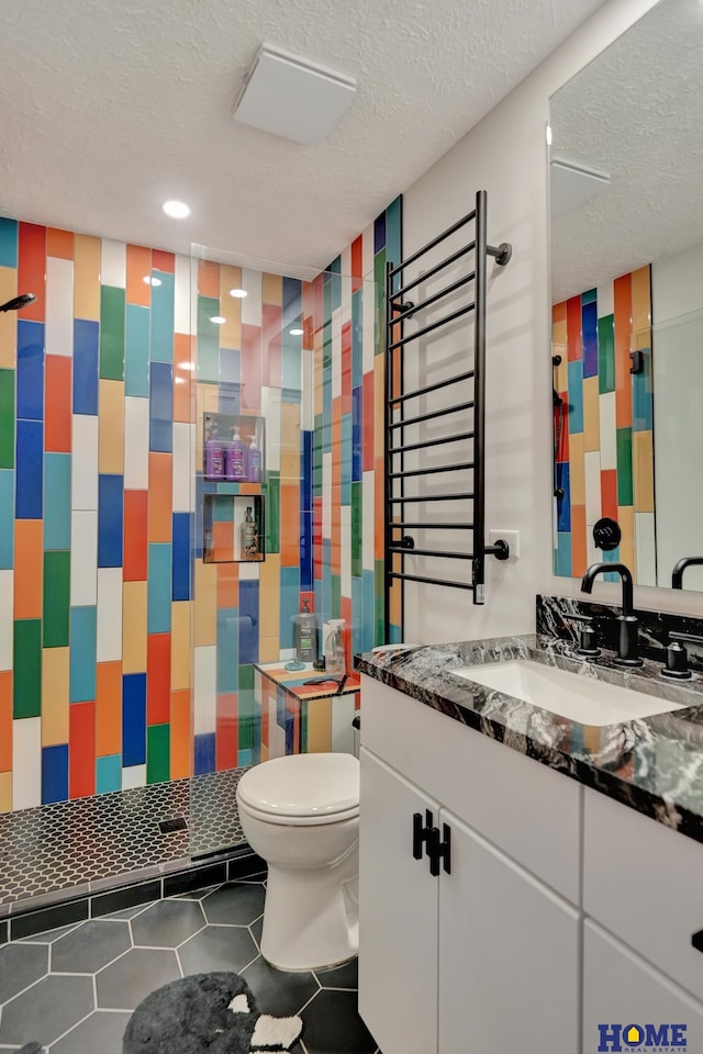 bathroom with toilet, radiator heating unit, a tile shower, and a textured ceiling