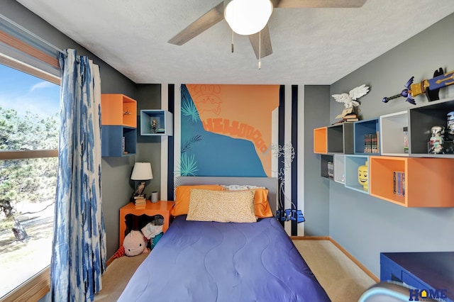 carpeted bedroom with a ceiling fan and baseboards