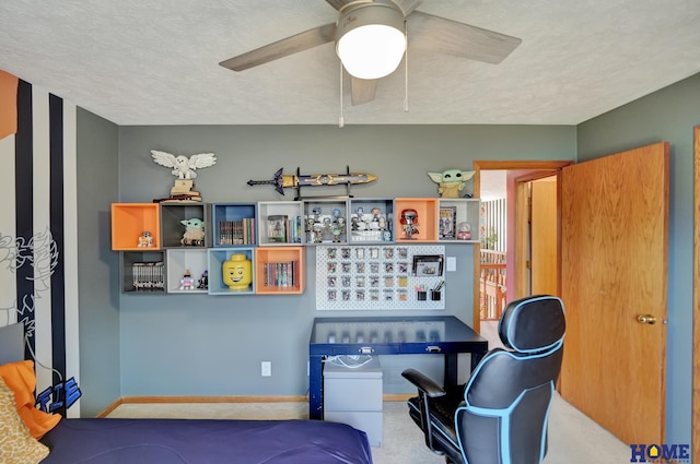 interior space with a ceiling fan, baseboards, a textured ceiling, and carpet flooring