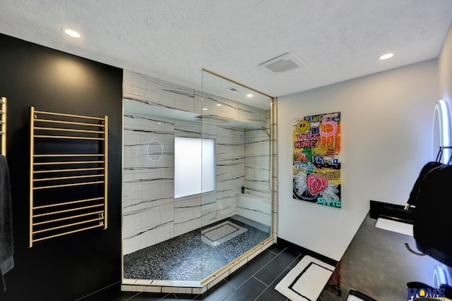 bathroom featuring radiator heating unit, a walk in shower, recessed lighting, and a textured ceiling