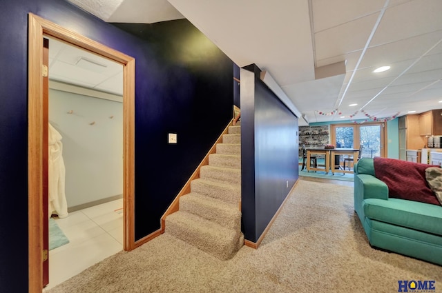 staircase featuring recessed lighting, baseboards, a drop ceiling, and carpet floors