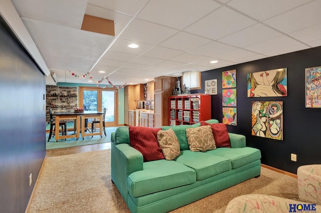 living area with recessed lighting, a drop ceiling, baseboards, and carpet floors