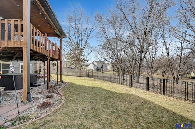 view of yard with a wooden deck, a fenced backyard, and a hot tub