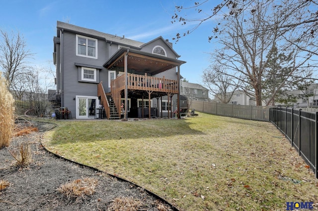 rear view of property featuring a fenced backyard, stairway, a lawn, and a deck