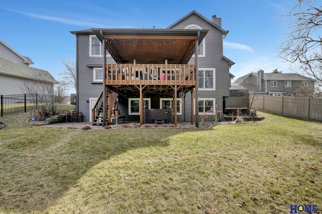 back of property featuring a deck, stairway, a fenced backyard, and a lawn