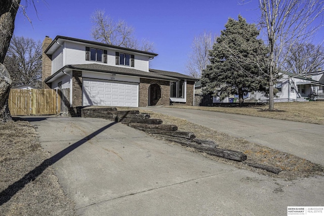 view of front of property with fence, concrete driveway, an attached garage, brick siding, and a chimney