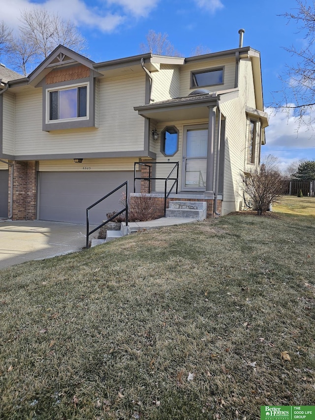 view of front of house featuring brick siding, a garage, concrete driveway, and a front yard