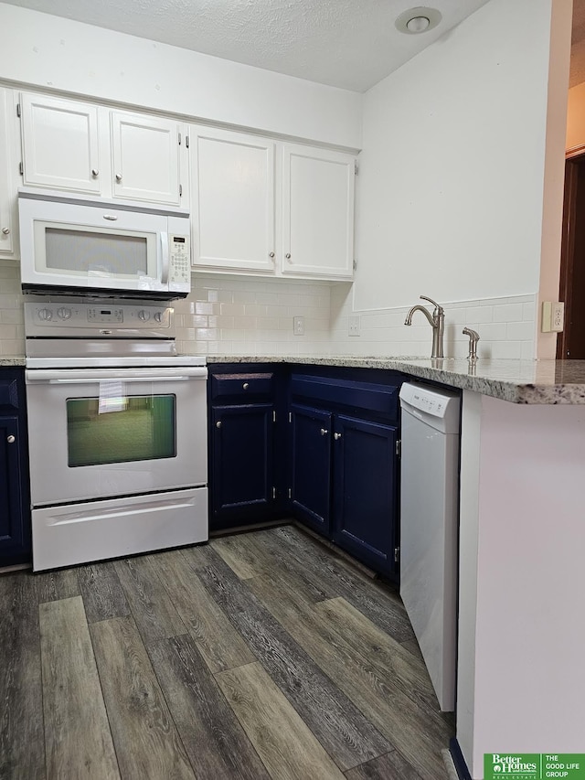 kitchen featuring dark wood finished floors, blue cabinetry, white appliances, and white cabinets