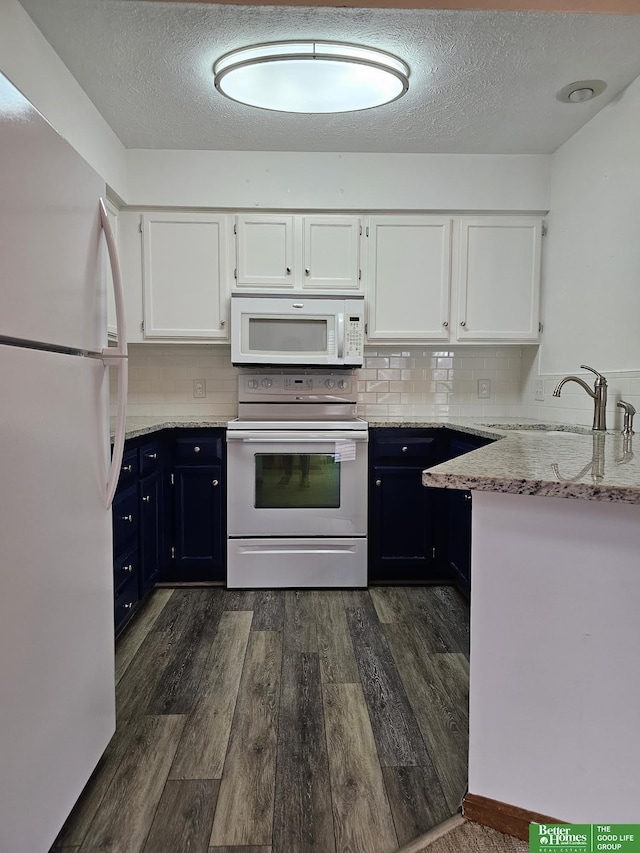 kitchen featuring dark wood-style flooring, white appliances, white cabinetry, and a sink