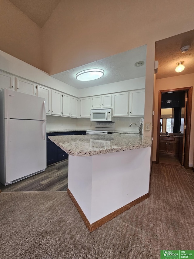 kitchen with white cabinetry, white appliances, a peninsula, and a textured ceiling