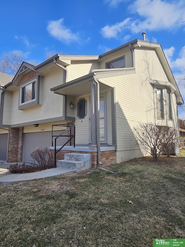 view of front of house featuring a garage and a front lawn