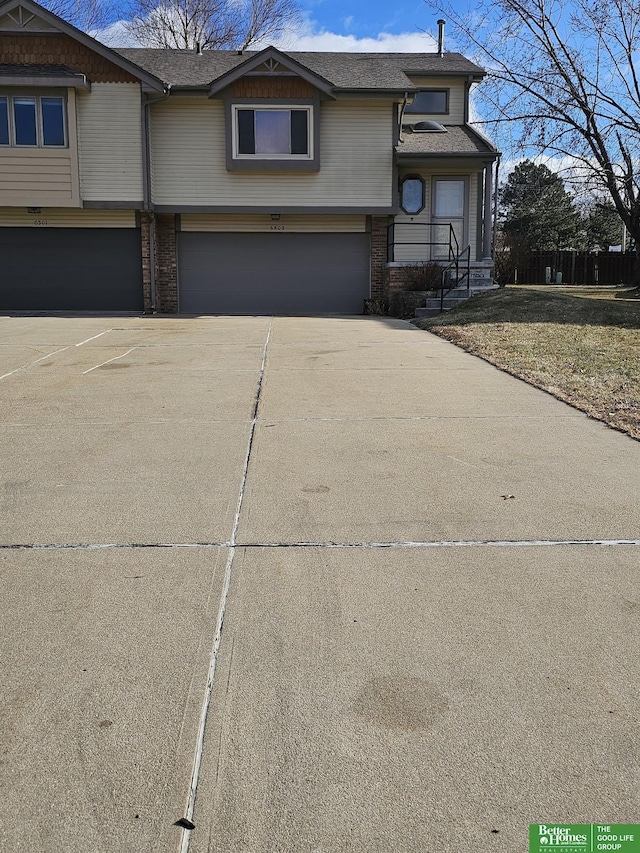 view of front facade featuring a garage, brick siding, and driveway