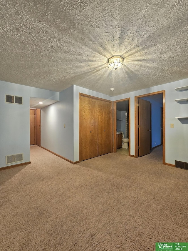 finished below grade area with carpet flooring, baseboards, and visible vents