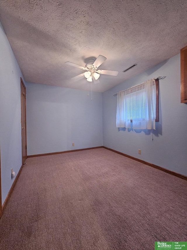 empty room featuring a ceiling fan, light colored carpet, visible vents, and baseboards