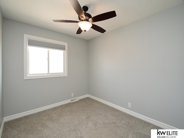 empty room with visible vents, a ceiling fan, baseboards, and carpet floors