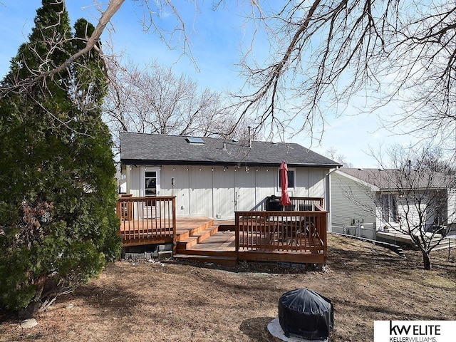 rear view of house featuring a wooden deck