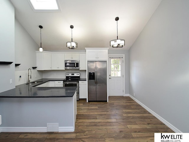 kitchen featuring a sink, visible vents, lofted ceiling, and appliances with stainless steel finishes