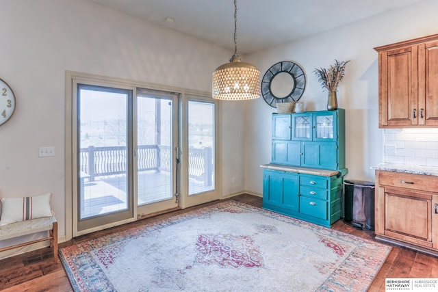 dining space with wood finished floors