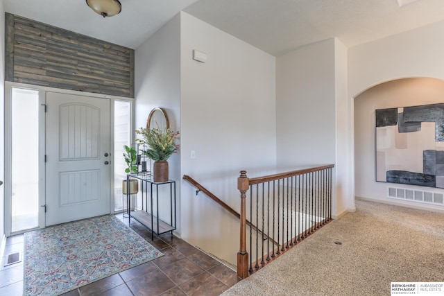 foyer featuring arched walkways and visible vents