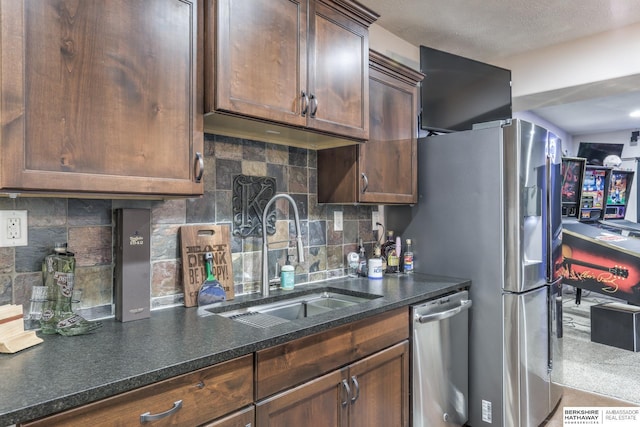 kitchen with a sink, decorative backsplash, and appliances with stainless steel finishes