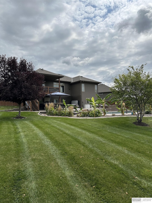 exterior space with stairway, a patio, and a yard