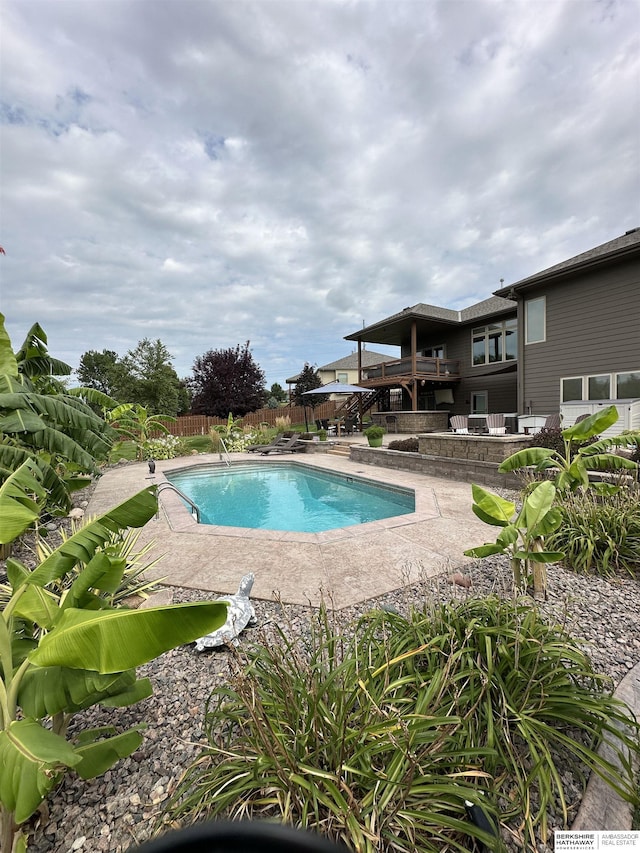 view of swimming pool featuring a fenced in pool, stairway, a deck, a fenced backyard, and a patio area