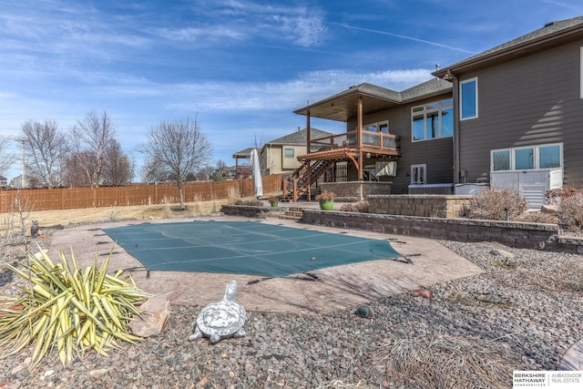 view of pool featuring a fenced in pool, stairs, a fenced backyard, a deck, and a patio