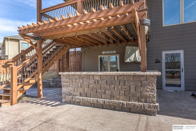 view of patio with stairs and a pergola