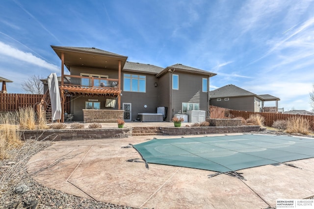 back of property with a fenced in pool, fence, stairway, central AC unit, and a patio