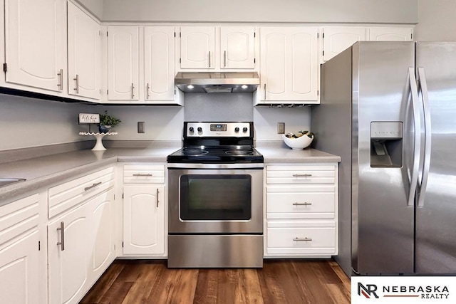 kitchen with under cabinet range hood, appliances with stainless steel finishes, dark wood finished floors, and white cabinets