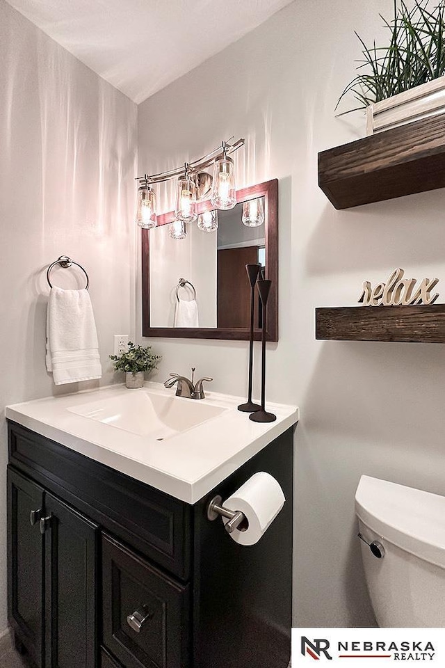 bathroom featuring vanity and toilet