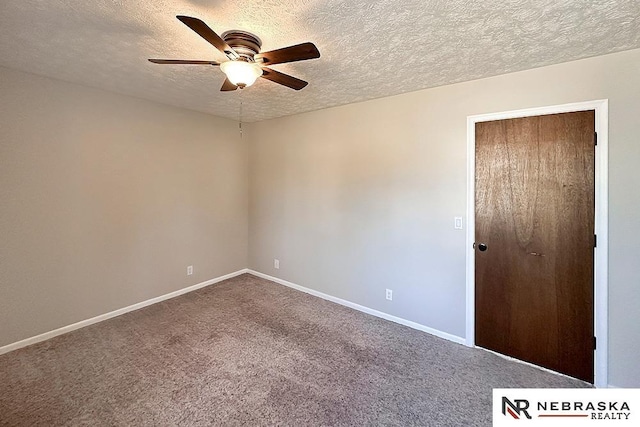 empty room with dark colored carpet, baseboards, a textured ceiling, and ceiling fan