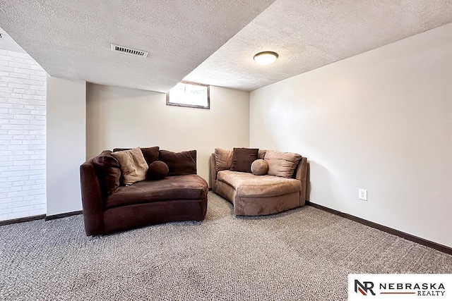 carpeted living room with visible vents, baseboards, and a textured ceiling