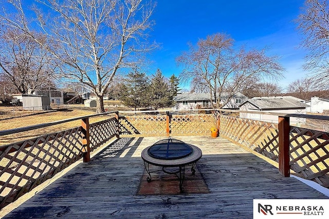 wooden terrace with a fire pit