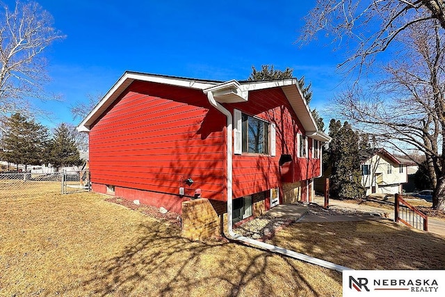 view of side of property featuring a yard and fence