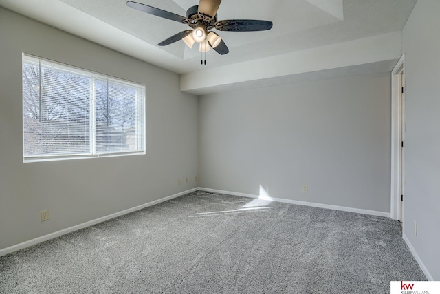 spare room featuring baseboards, carpet, and a ceiling fan