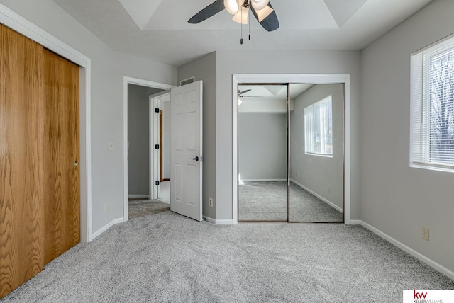 unfurnished bedroom with visible vents, baseboards, ceiling fan, and carpet flooring