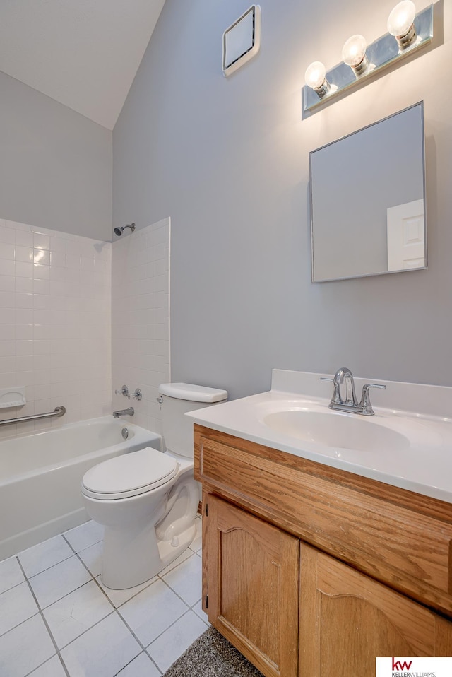 bathroom with vanity, tile patterned flooring, vaulted ceiling, shower / washtub combination, and toilet