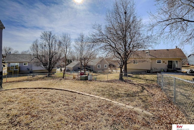 view of yard with a fenced backyard and a residential view