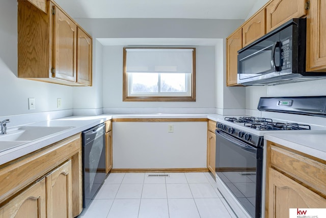 kitchen featuring visible vents, light countertops, light tile patterned flooring, black appliances, and a sink