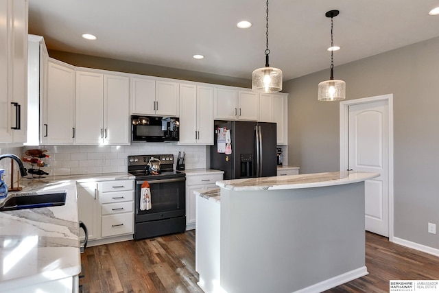 kitchen with tasteful backsplash, a center island, dark wood finished floors, black appliances, and a sink