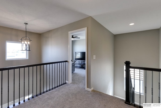 hall featuring an upstairs landing, a notable chandelier, recessed lighting, carpet flooring, and baseboards