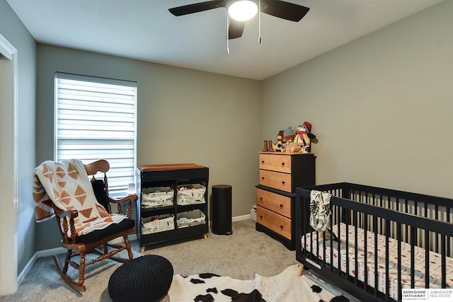 carpeted bedroom with baseboards and a ceiling fan