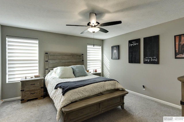 bedroom featuring baseboards, light carpet, and a ceiling fan