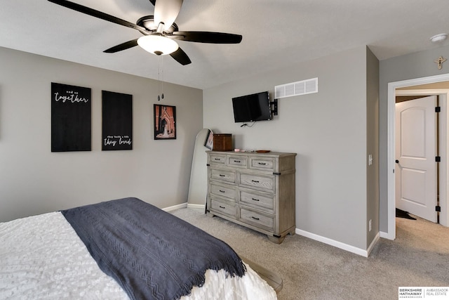 bedroom with visible vents, light carpet, and baseboards