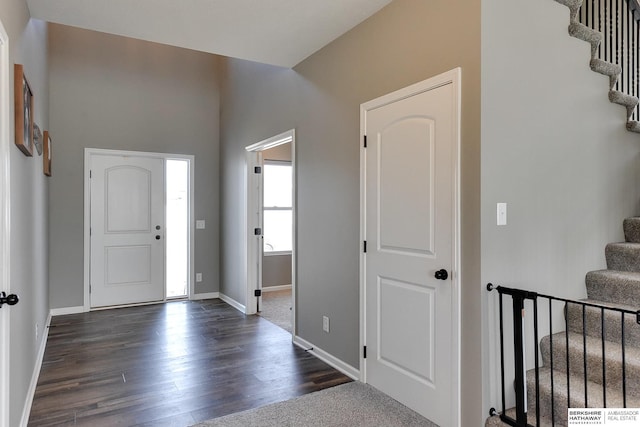 entryway featuring stairway, baseboards, and dark wood finished floors