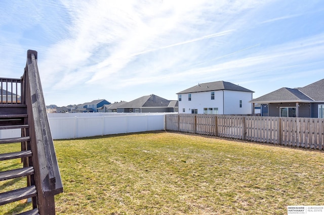 view of yard with a residential view and fence